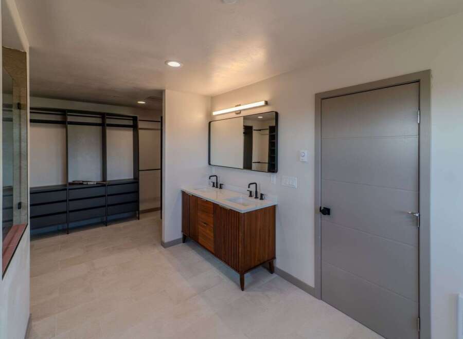 Step into luxury with this stunning bathroom featuring a modern vanity and sleek design.