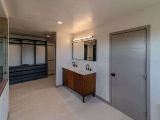 Step into luxury with this stunning bathroom featuring a modern vanity and sleek design.