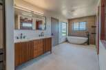 Step into luxury with this stunning bathroom featuring a sleek, modern design.