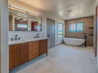 Step into luxury with this stunning bathroom featuring a sleek, modern design.