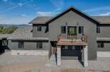 This stunning modern home boasts a sleek, contemporary design with a striking dark gray exterior.