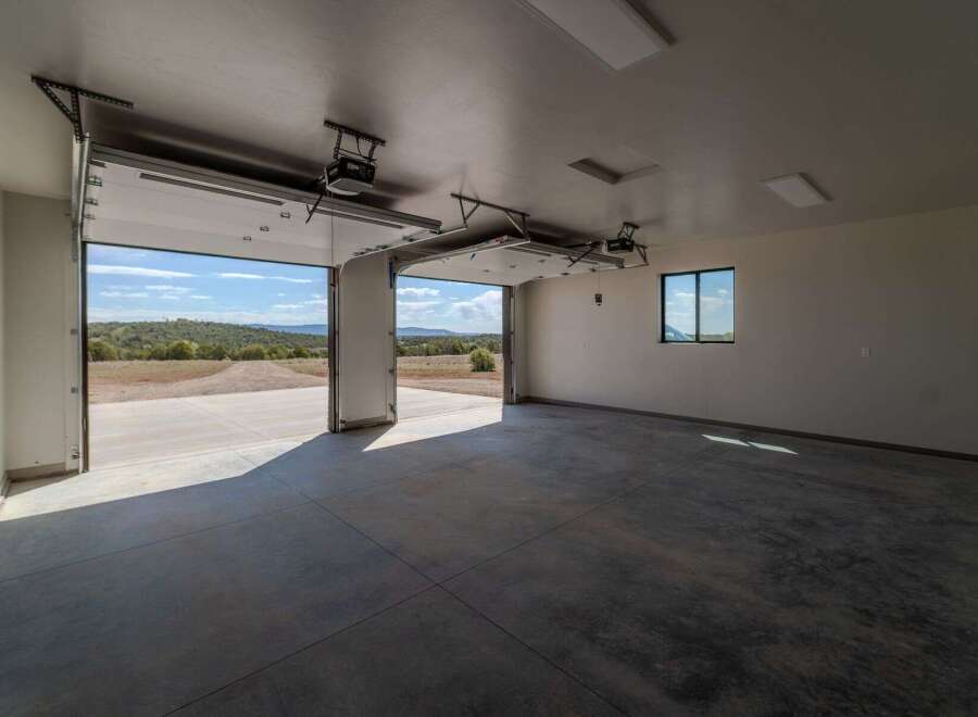 This spacious garage offers ample room for vehicles and storage, featuring a sleek, modern design.