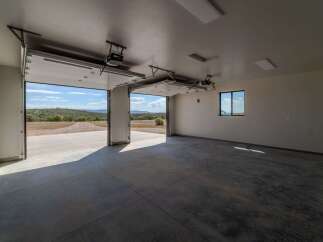 This spacious garage offers ample room for vehicles and storage, featuring a sleek, modern design.