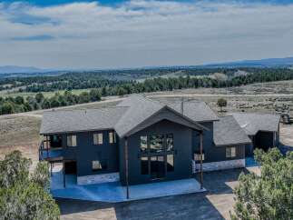 Discover your dream home in this stunning property! This modern residence boasts a sleek design with expansive windows, offering breathtaking views of the surrounding landscape.