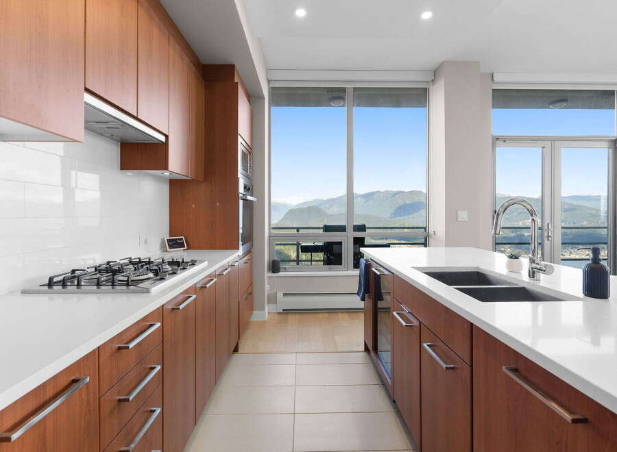 Experience luxury living in this stunning kitchen with breathtaking mountain views.