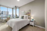 Experience luxury living in this stunning bedroom with breathtaking city views.