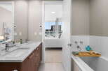 Step into luxury with this stunning bathroom featuring a double vanity with a marble countertop and sleek fixtures.