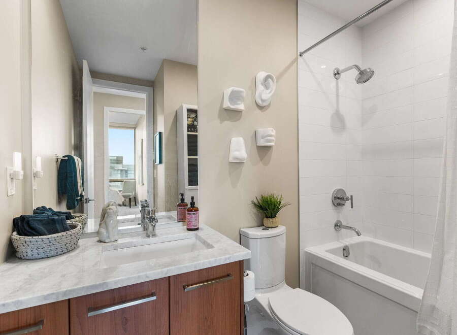 Step into luxury with this stunning bathroom! Featuring a sleek marble countertop, modern fixtures, and a stylish shower, this space is designed for both comfort and elegance.