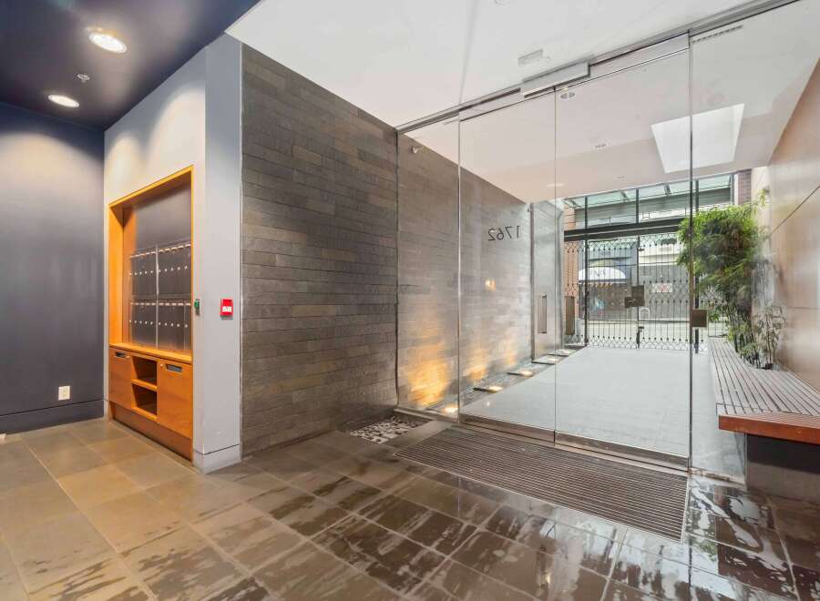 Discover modern living in this stylish apartment building lobby, featuring sleek slate tile walls and integrated lighting.