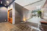 Discover modern living in this stylish apartment building lobby, featuring sleek slate tile walls and integrated lighting.