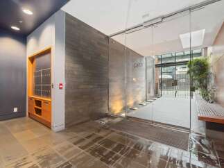 Discover modern living in this stylish apartment building lobby, featuring sleek slate tile walls and integrated lighting.
