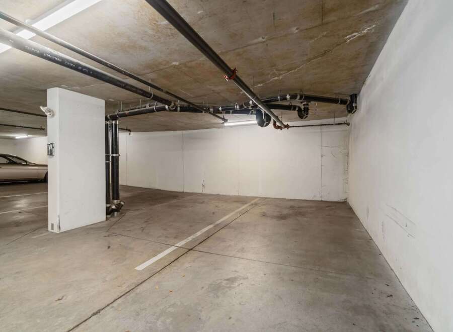 Discover this spacious parking spot in a secure underground garage, perfect for protecting your vehicle from the elements.