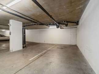 Discover this spacious parking spot in a secure underground garage, perfect for protecting your vehicle from the elements.