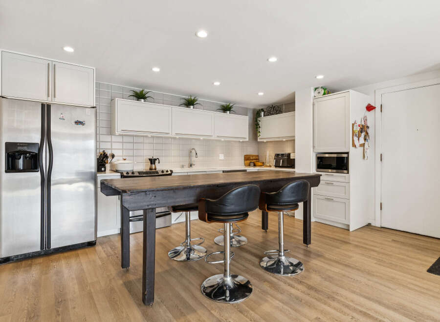 This stunning kitchen boasts a modern design with sleek stainless steel appliances and ample cabinet space.