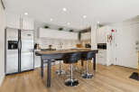This stunning kitchen boasts a modern design with sleek stainless steel appliances and ample cabinet space.