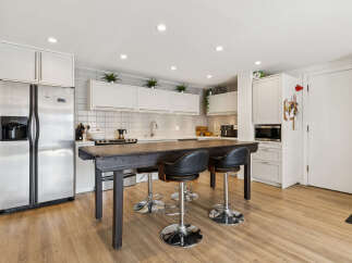 This stunning kitchen boasts a modern design with sleek stainless steel appliances and ample cabinet space.