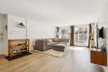 Step into this inviting living space, featuring a modern sectional sofa and a cozy ottoman, perfect for relaxation.