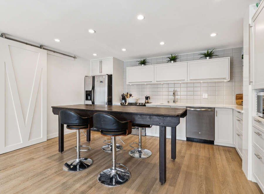 Step into this stunning kitchen, featuring a stylish island perfect for casual dining and entertaining.
