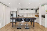 This modern kitchen boasts a sleek design with a large island perfect for entertaining.