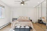 This inviting bedroom boasts a serene ambiance with its neutral color palette and ample natural light.