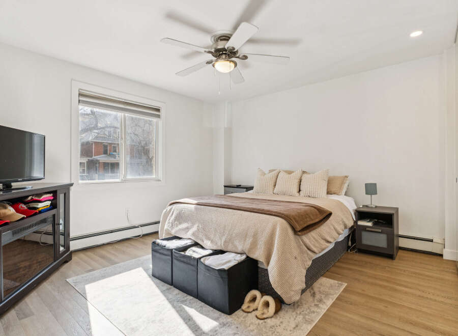 This inviting bedroom boasts a cozy atmosphere with its neutral color palette and ample natural light.