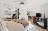 Step into this bright and airy bedroom, featuring a large mirrored closet and a cozy bed.
