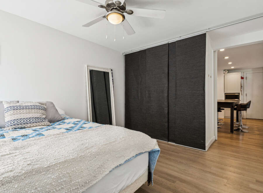 This cozy bedroom features a comfortable bed with stylish bedding and a decorative throw.