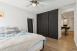 This cozy bedroom features a comfortable bed with stylish bedding and a decorative throw.
