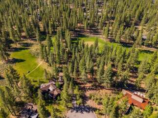 Discover a stunning property nestled amidst a lush forest and a meticulously maintained golf course.