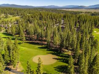 Discover the tranquility of this stunning golf course property, nestled amidst a lush forest.