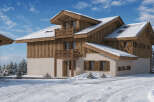 Experience the charm of this stunning wooden chalet nestled in a serene winter landscape.