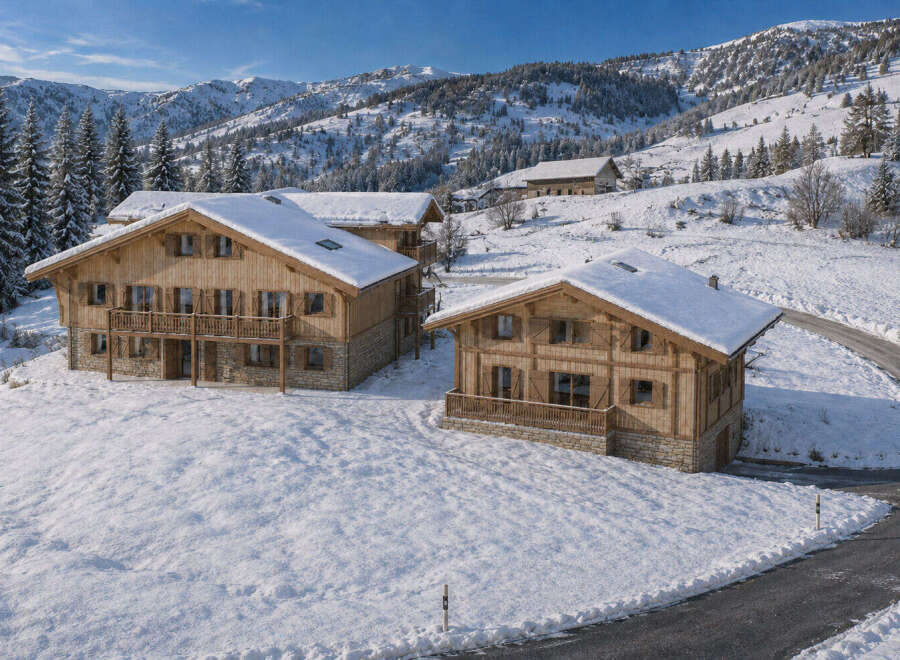 Experience luxurious mountain living in this stunning chalet nestled in a snowy alpine landscape.