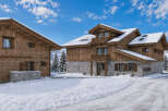 Experience the ultimate winter retreat in this stunning log cabin, nestled amidst snow-covered mountains and evergreen trees.