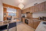 This stunning kitchen boasts modern cabinetry, granite countertops, and a sleek built-in oven.
