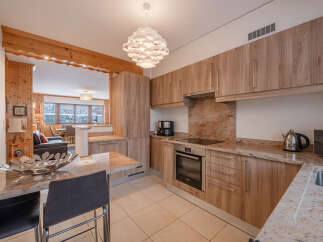 This stunning kitchen boasts modern cabinetry, granite countertops, and a sleek built-in oven.