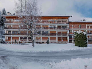 Discover a charming property nestled in a snowy landscape, perfect for a winter getaway.
