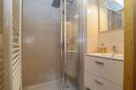 Step into a modern bathroom featuring a sleek shower enclosure and stylish vanity.