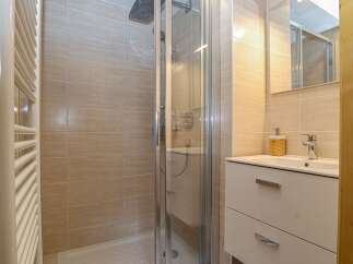 Step into a modern bathroom featuring a sleek shower enclosure and stylish vanity.