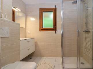 Step into this beautifully designed bathroom, featuring a modern shower and elegant vanity.