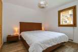 This cozy bedroom features a comfortable bed with a stylish headboard, perfect for a relaxing retreat.