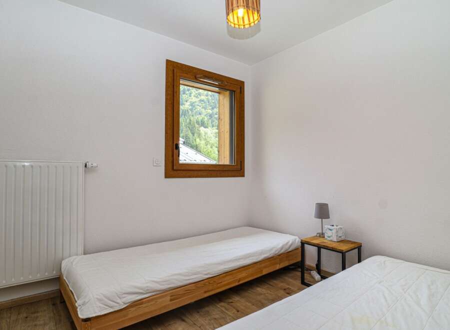 Discover a cozy bedroom retreat with natural light and a serene ambiance.