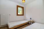 Discover a cozy bedroom retreat with natural light and a serene ambiance.