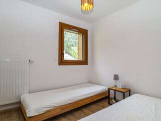 Discover a cozy bedroom retreat with natural light and a serene ambiance.