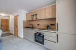This modern kitchen boasts sleek cabinetry and a minimalist design, perfect for contemporary living.