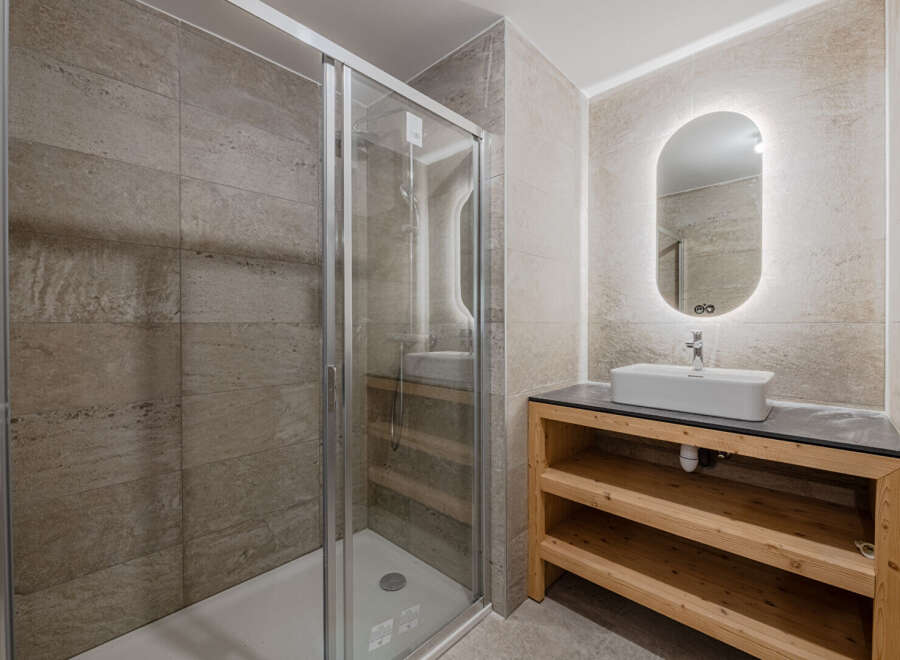 Step into a modern bathroom oasis! This stunning space features a sleek glass shower, perfect for a refreshing start to your day.