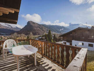 Enjoy breathtaking mountain views from this charming balcony.