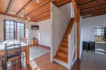 This charming property features a warm and inviting interior with exposed wooden beams and a cozy atmosphere.