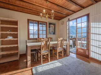 This charming dining room offers a warm and inviting atmosphere, perfect for enjoying meals with family and friends.