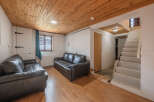 Discover the charm of this inviting living space, featuring a cozy seating area with comfortable leather sofas.