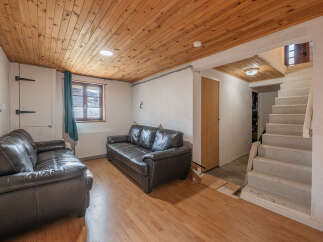 Discover the charm of this inviting living space, featuring a cozy seating area with comfortable leather sofas.